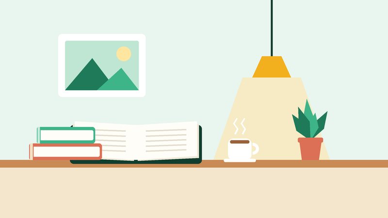 كتابٌ مفتوح وكوبٌ تحت مصباحٍ معلّق