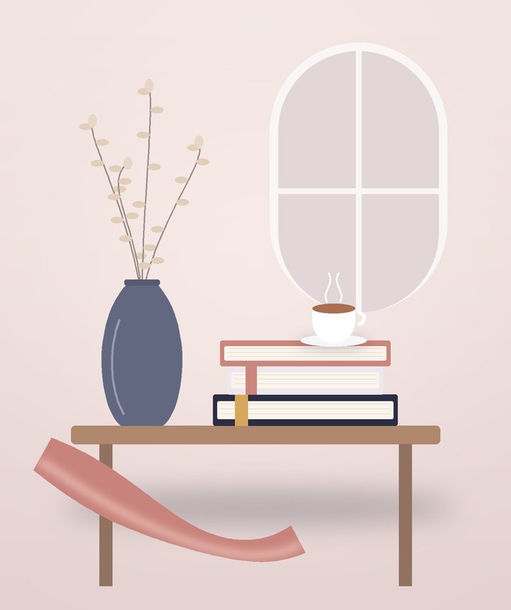 طاولةٌ صغيرة عليها كتبٌ وفنجان بجانب مزهريّة