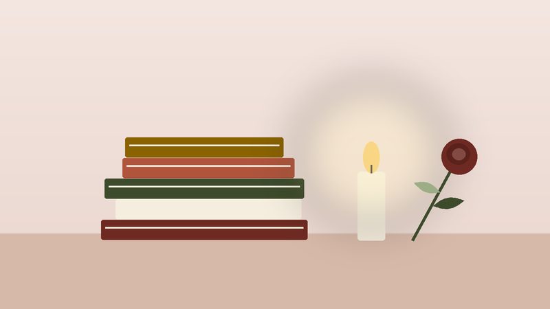 كتبٌ مكدّسة بجانب شمعةٍ ووردة